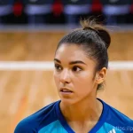 리시브 기술 향상 팁 - **Prompt 1: Intense Focus and Perfect Reception in Action**
A highly athletic female volleyball ...